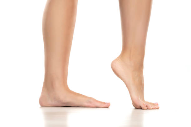istock Side view of a beautifully cared female feet on a white background. 1596623287