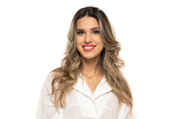 beautiful young happy women with makeup and long wavy hair on a white background. beautiful young happy women with makeup and long wavy hair on a white studio background. teenage girl before and after make up stock pictures, royalty-free photos & images