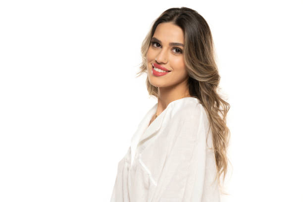 beautiful young happy women with makeup and long wavy hair on a white background. beautiful young happy women with makeup and long wavy hair on a white studio background. teenage girl before and after make up stock pictures, royalty-free photos & images
