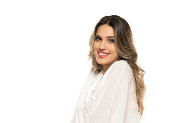 beautiful young happy women with makeup and long wavy hair on a white background. beautiful young happy women with makeup and long wavy hair on a white studio background. teenage girl before and after make up stock pictures, royalty-free photos & images