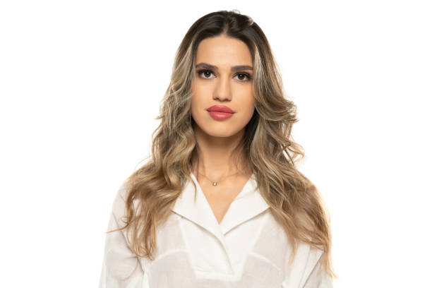 beautiful young women with makeup and long wavy hair on a white background. beautiful young women with makeup and long wavy hair on a white studio background. teenage girl before and after make up stock pictures, royalty-free photos & images