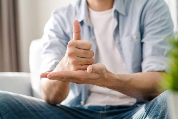 istock Happy young deaf man using sign Language to communicate with other people. 1596635088
