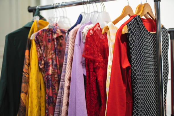 istock Many different colored women's clothes on hangers in a store 1596636177