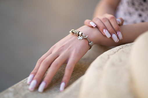 close-up of a girl's hand with a beautiful manicure and a jewelry bracelet on her hand