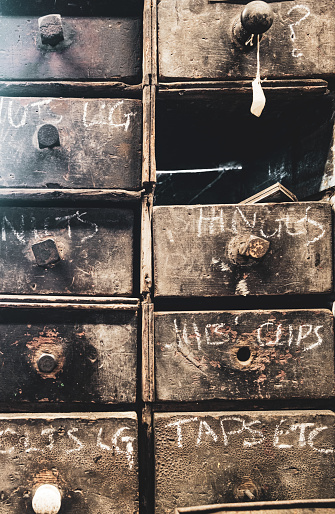 Chalked labels on wooden storage drawers at Combe Mill, Oxfordshire