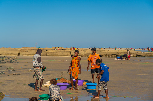 Morondava, Madagascar - May 31.2023: People at the coastline from Morondava fishing