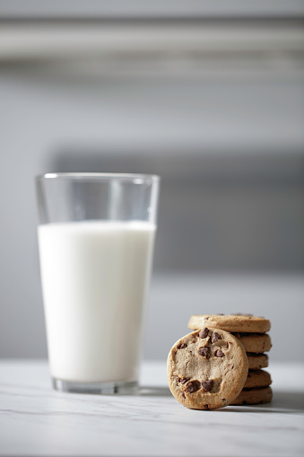 Glass of milk and cookies on a marble table
