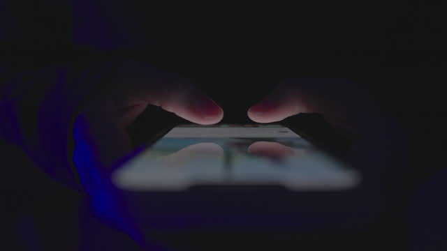Close-up Hand Using smart phone at night