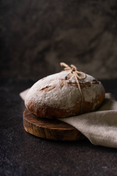 istock Fresh organic homemade artisan ciabatta bread on dark rustic background. sourdough bread 1596766557