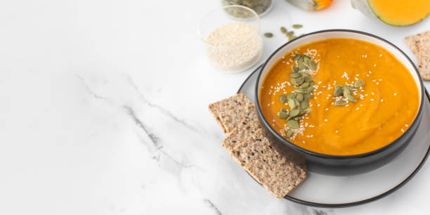 istock A bowl of pumpkin soup with mashed potatoes and seeds. Autumn menu. Copy space 1596778642