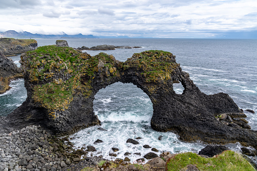 Amazing stone arch Gatklettur basalt rock on Atlantic coast of Arnarstapi in Iceland