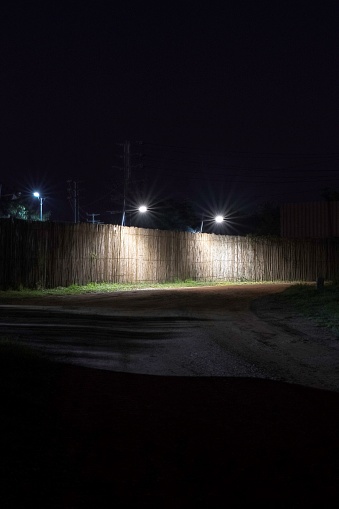 simple wooden fence at night illuminated by street light