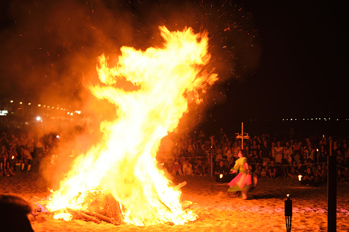 Ignition of the bonfire on the shore of the beach on the day of San Juan (pagan ritual). The actors dance on the beach around the burning bonfire
