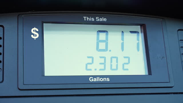 Fuel pump screen showing rising price of gasoline at gas station