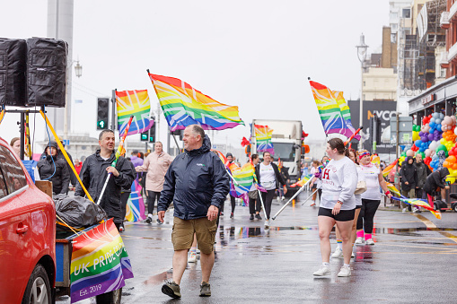 Brighton, England - August 5th 2023: UK Pride Colour Guard at the pride parade. The Brighton & Hove Pride Parade 2023 begins in wet and rainy conditions on August 05, 2023, in Brighton, England.