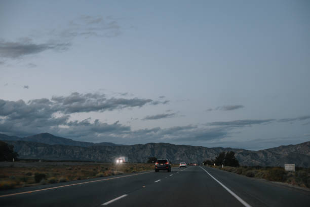 Residential area in California, near Palm Springs, with palm trees and mountains in the background.
