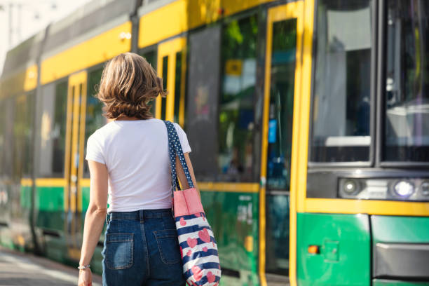 Woman heading for a tram on a sunny day
