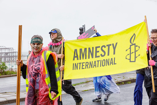 Brighton, England - August 5th 2023: Amnesty International at the pride parade. The Brighton & Hove Pride Parade 2023 begins in wet and rainy conditions on August 05, 2023, in Brighton, England.