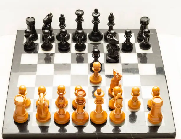 Chess board made of marble with wooden chess pieces
