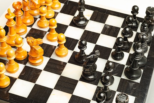 Chess board made of marble with wooden chess pieces