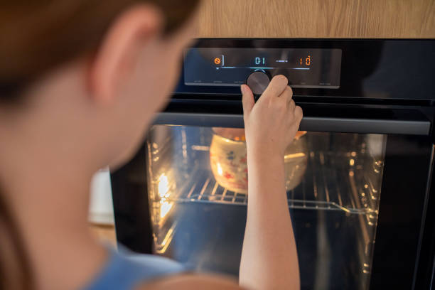 istock Woman making lunch in oven at domestic kitchen 1596926102