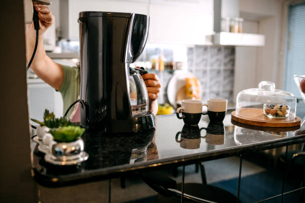 istock Woman preparing coffee at home 1596969203