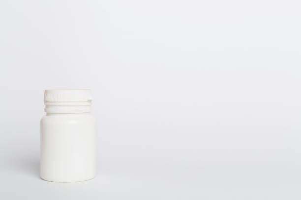 istock Plastic bottle for vitamins on color background 1596973970