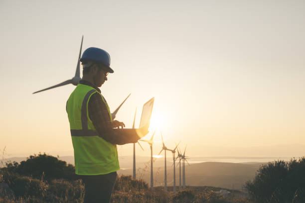 istock Renewable Energy Systems Innovator: Engineer Planning at Wind Turbines Farm 1596974262