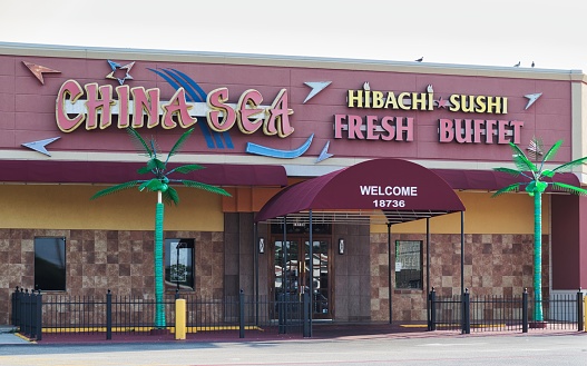 Houston, Texas USA 07-30-2023: China Sea Hibachi Buffet storefront exterior in Houston, TX. Local Chinese restaurant and buffet in a strip mall.