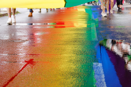 Brighton, England - August 5th 2023: The infamous rainbow flag makes its way from the Brighton Pier into the streets. The Brighton & Hove Pride Parade 2023 begins in wet and rainy conditions on August 05, 2023, in Brighton, England.