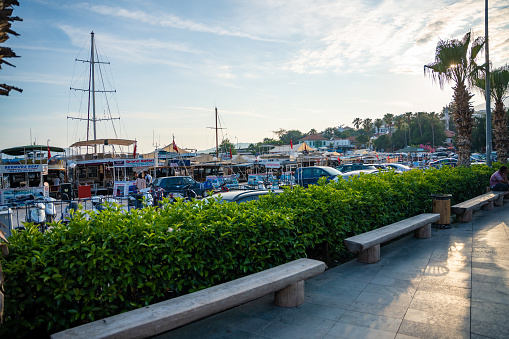 Kas, Turkey - June 7, 2023: Street view in the Kas old town with old marina at evening. Kas Town is popular tourist destination in Turkey. High quality photo