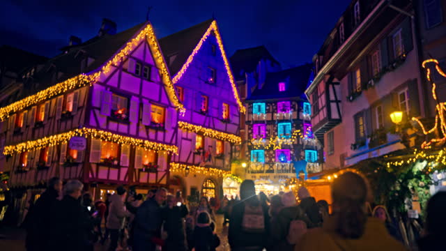 WS People strolling around at a lively Christmas market in the town of Colmar