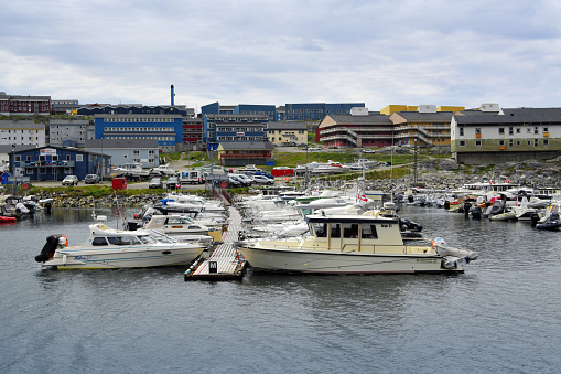 Nuuk / Godthåb, Sermersooq, Greenland: South Nuussuaq neighborhood and marina - moored boats and residential area along the waterfront with services for the marina.