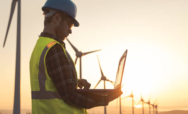 istock Renewable Energy Systems Innovator: Engineer Planning at Wind Turbines Farm 1597092006