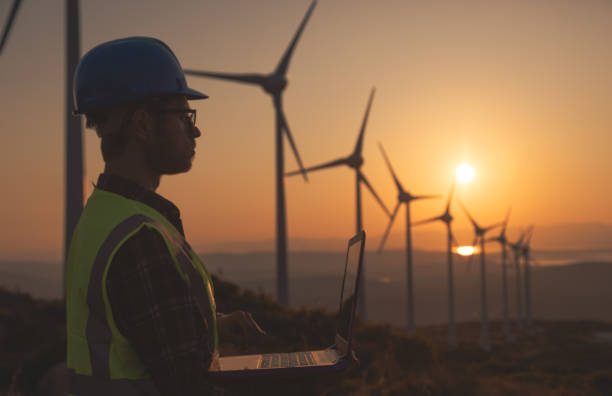istock Renewable Energy Systems Innovator: Engineer Planning at Wind Turbines Farm 1597092011