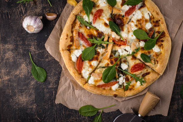 Italian pizza with feta cheese, tomato and basil stock photo