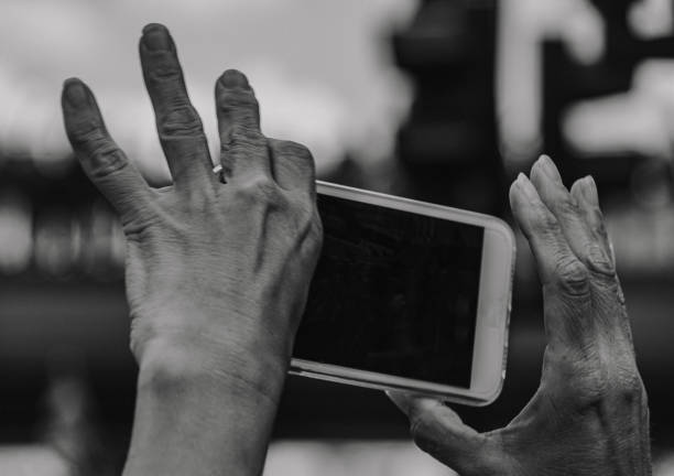 istock a person holding a cellphone against sky 1597132902