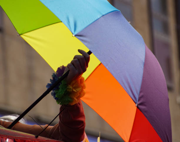 istock Cropped hand holding a colorful umbrella 1597139575