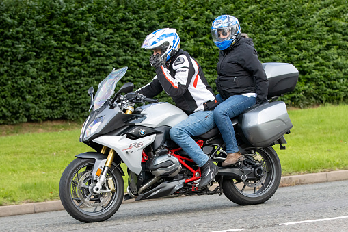 Whittlebury,Northants.,UK - Aug 6th 2023. 2018 BMW R1200 RS Sport SE motorcycle travelling through an English village.