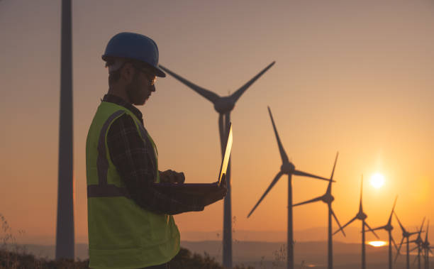 istock Renewable Energy Systems Innovator: Engineer Planning at Wind Turbines Farm 1597196158