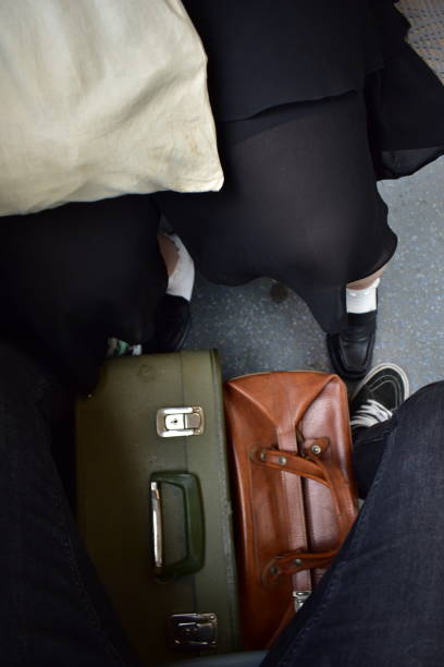 istock Two travelers with vintage suitcases 1597208406