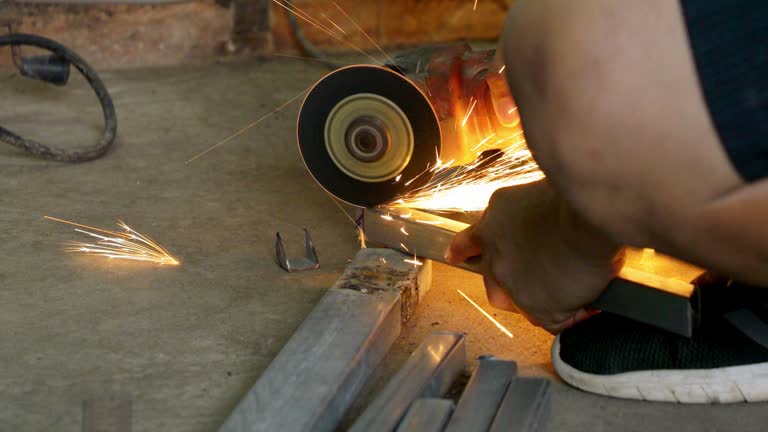 Asian worker is using steel cutting tools.