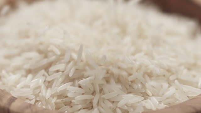 Slow motion closeup filling bowl with basmati rice
