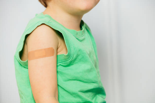 istock Close-up of a handsome boy with band-aid patch on his shoulder 1597366246