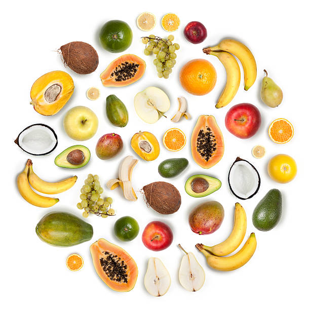 Healthy fruits arranged in a round composition on white background Composition made with many healthy fruits arranged together in a circular round shape on white background: apples, bananas, lemons, oranges, mangos, pears, avocado, grapefruit, coconut kaleidoscope pattern photos stock pictures, royalty-free photos & images