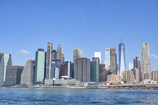 Skyline of Manhattan, New York. Downtown financial district on a clear sky day. Freedom tower is in the view, along with Hudson / East river.