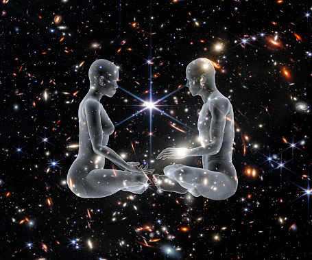 Man and woman silhouettes in Yoga pose on a galactic background.