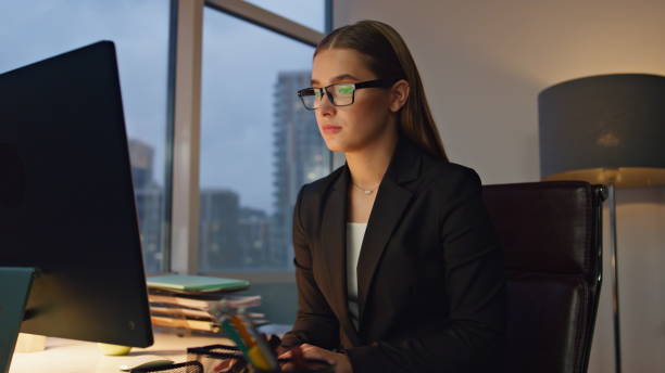 istock Focused manager working late in office. Successful ceo woman surfing internet 1597490422