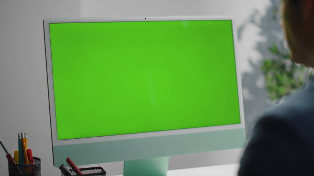 istock Chroma key computer monitor at workplace closeup. Specialist working surfing web 1597499360