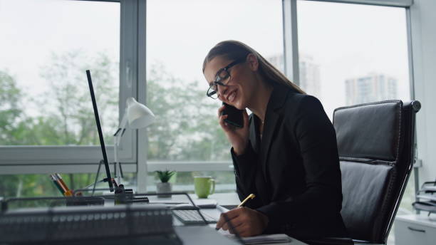 istock Sales agent talking phone consulting client closeup. Smiling woman work office 1597509388